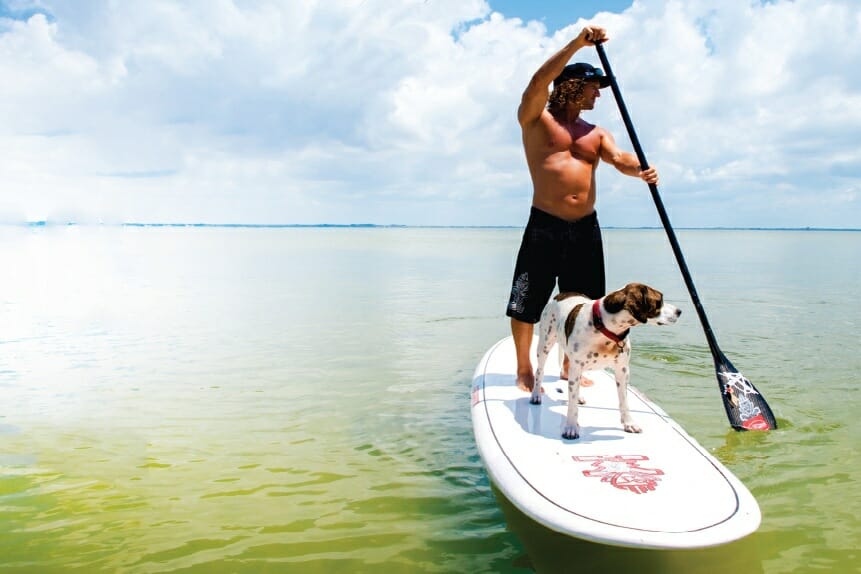 Girard Middleton and dog Kona stand up paddle boarding