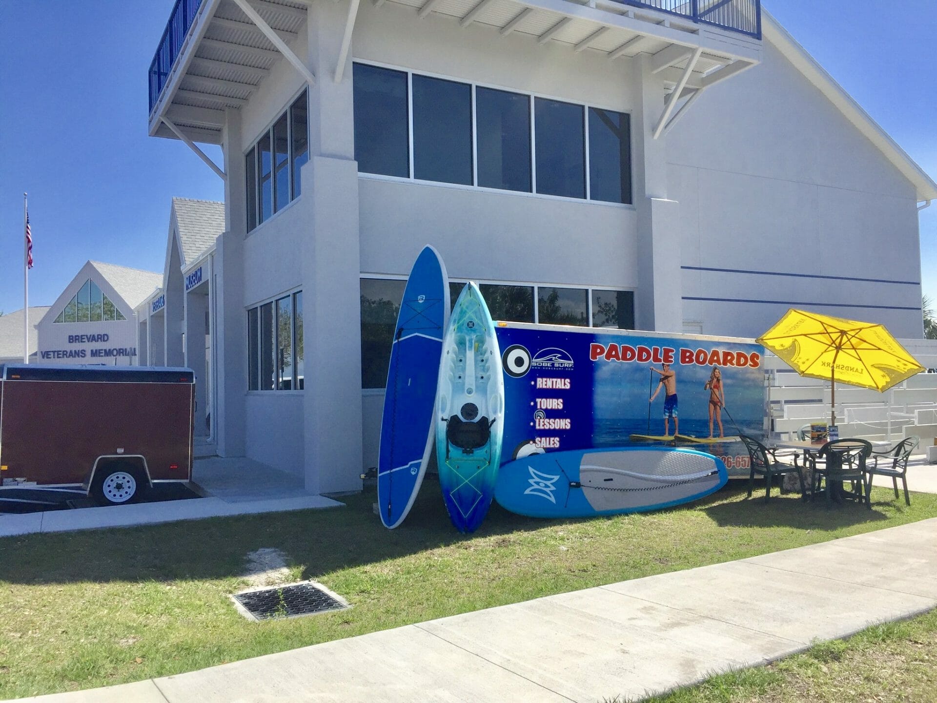 SoBe Surf & Paddle board rentals and kayak rentals set up at Brevard Veterans Memorial Park SoBe Surf & Paddle board rentals kayak rentals Brevard Veterans Memorial Park