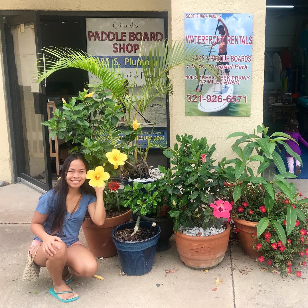 sobe surf and paddle store front with wife and flowers